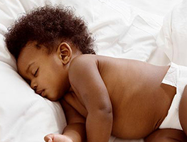 Newborn baby sleeping on white bedding