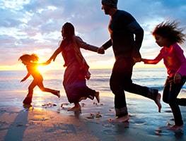 Family running on a beach